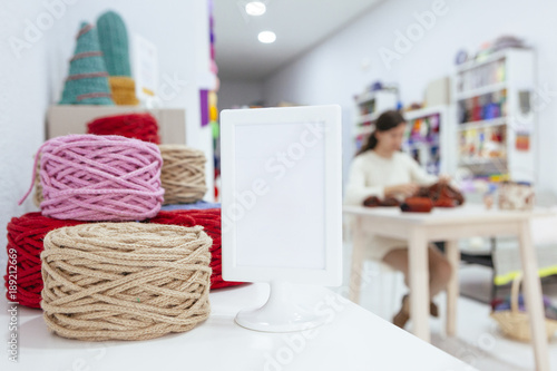 Wallpaper Mural set of big wool yarns and a blank sign at a retail shop Torontodigital.ca