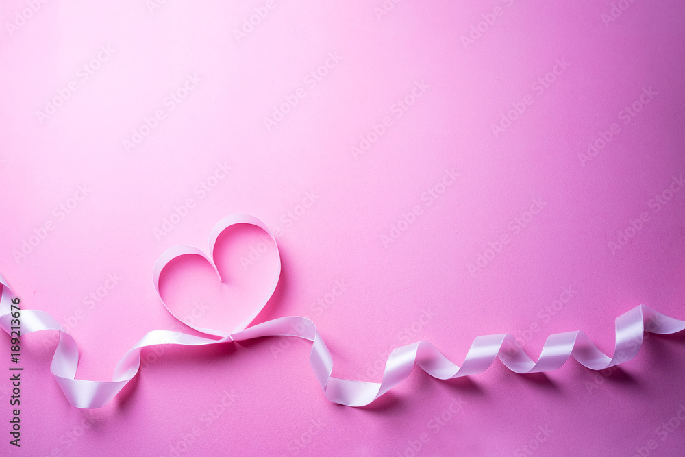 Valentines Day background with pink heart. Heart shape from ribbons. Top view