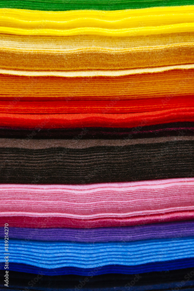 Fototapeta premium pattern of colorful pieces of clothes sorted by color