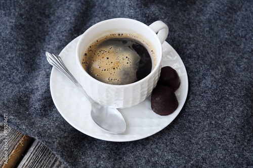 Delicious fresh tasty coffee on grey plaid