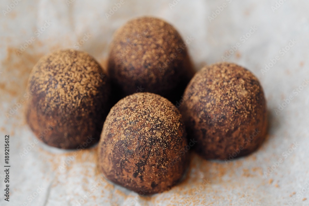 Delicious chocolates truffles with cocoa on paper Delicious chocolates truffles with cocoa on paper