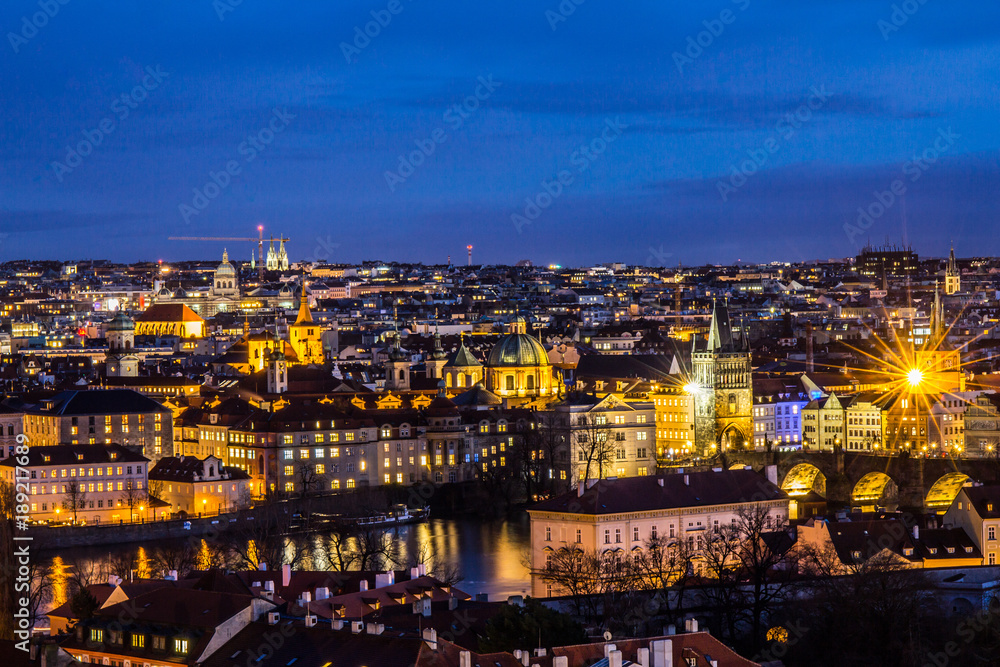 Beautiful Night view over the Vltava river, Charles bridge, the embankment Smetanovo, tower old city, Church St. Assisi and whole Prague. Popular European travel destination. Chech Republic.