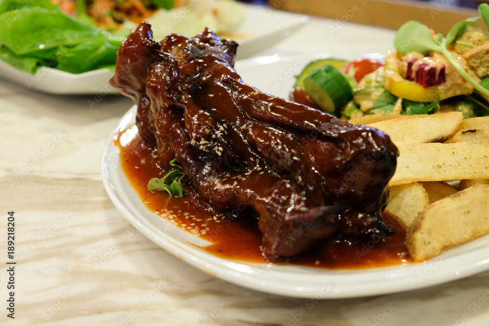 Pork rip barbecue steak serve with french fries and organic salad side dish Pork rip barbecue steak serve with french fries and organic salad side dish