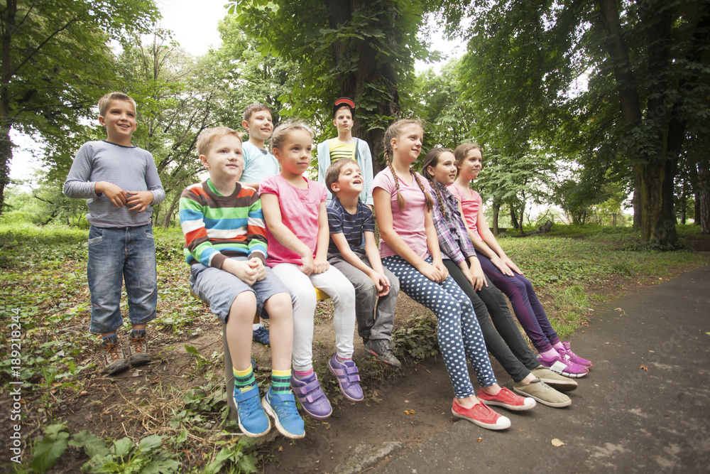 Group of children  on a park bench