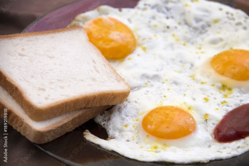 English breakfast, fried eggs with toast on an old textured table English breakfast, fried eggs with toast on an old textured table