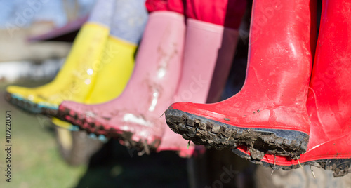 Three girls in dirty gumboots photo