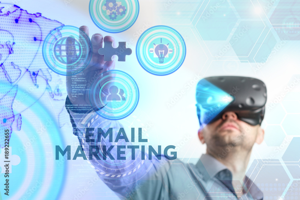 Business, Technology, Internet and network concept. Young businessman working in virtual reality glasses sees the inscription: Email marketing Business, Technology, Internet and network concept. Young businessman working in virtual reality glasses sees the inscription: Email marketing