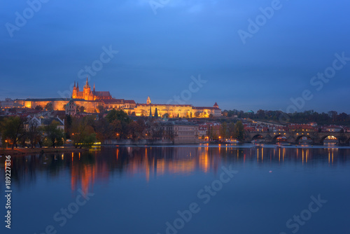 Prague, view of illuminated Prague castle (Prazsky Hrad) with reflection in the water, night scenic cityscape, world famous historical heritage of Czech Republic © larauhryn
