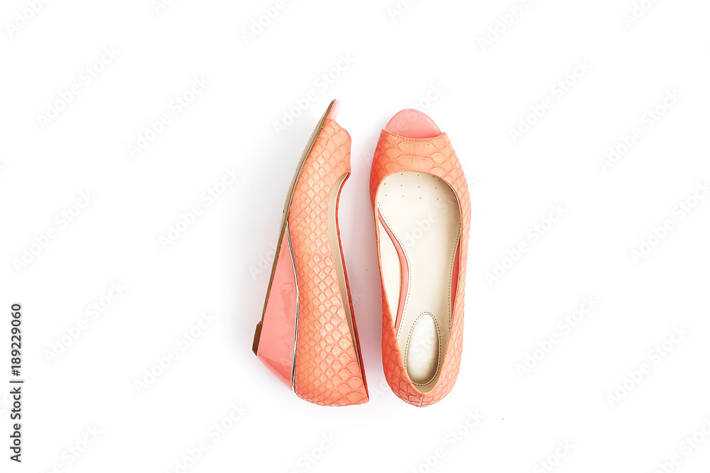 Fototapeta premium Fashionable medium heeled women's leather wedge shoes isolated on white.