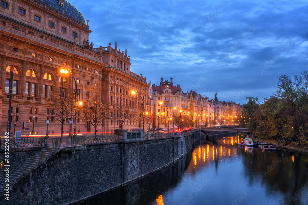 Embankment of Prague historic district, beautiful night cityscape with building of National theatre, Czech Republic