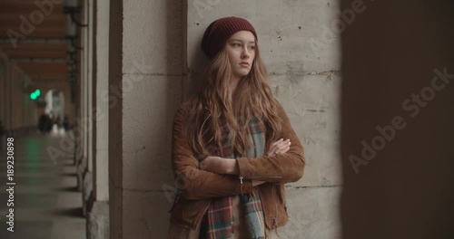 Beautiful sad anxious woman in a city street.