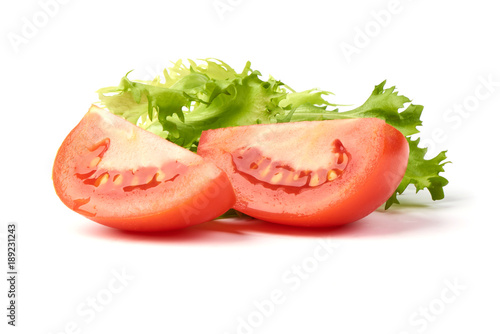 Slice tomato with green fresh salad, isolated on white background.