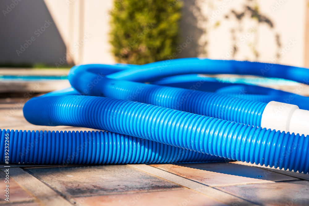 Blue plastic hose for cleaning a swimming pool, Yesulskaya, Krasnodar, Russia. Close-up. Blue plastic hose for cleaning a swimming pool, Yesulskaya, Krasnodar, Russia. Close-up.