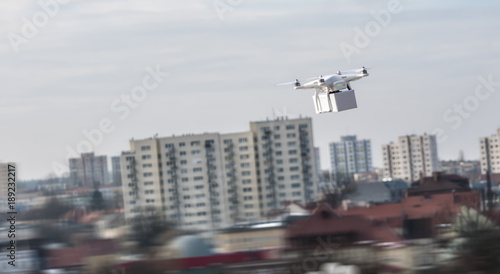 Technological delivery innovation - fast drone delivery concept above town