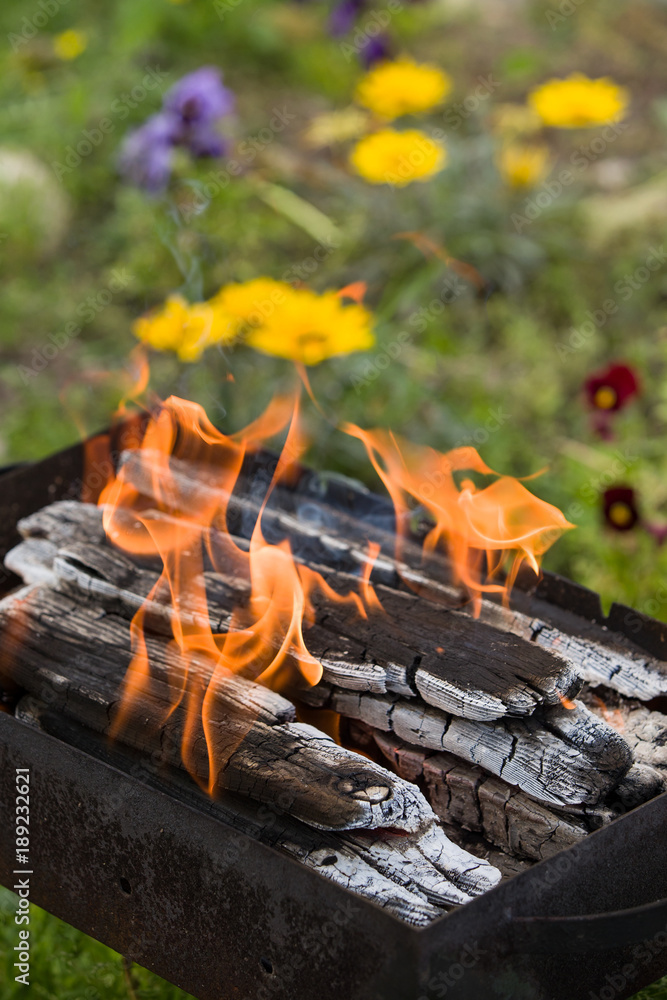 Barbecue grill with glowing coals. Dirty Charcoal Grill on garden background. outddors. Barbecue grill with glowing coals. Dirty Charcoal Grill on garden background. outddors.