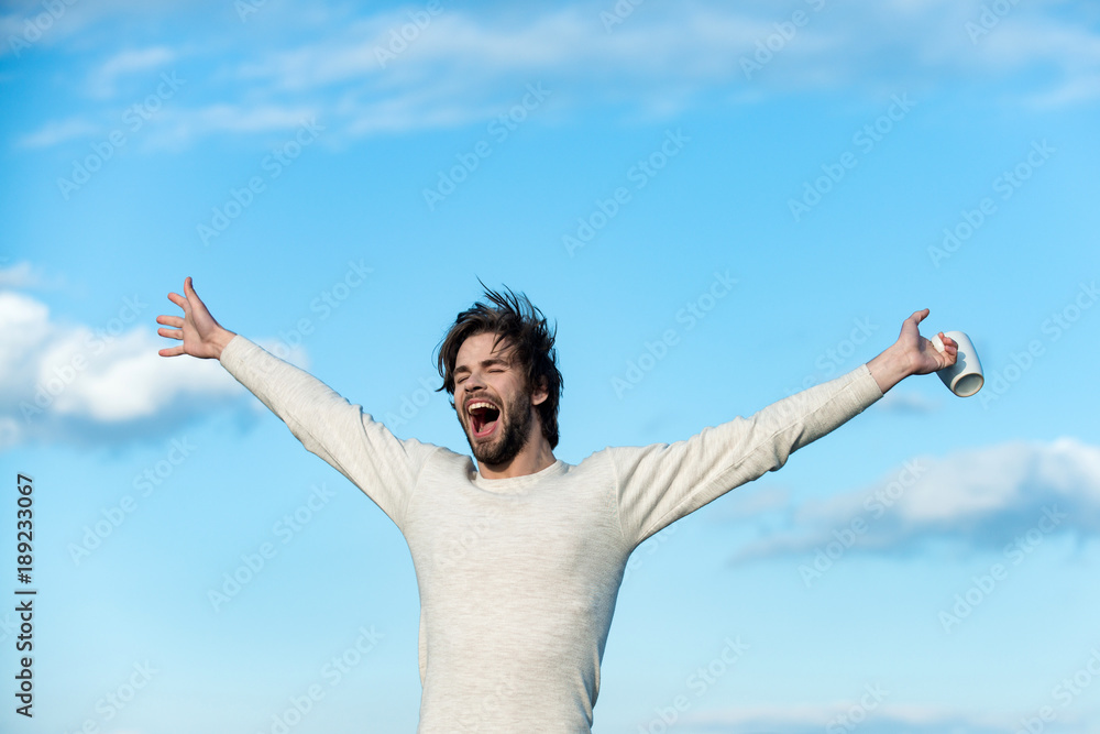 Man with disheveled hair hold cup with mulled wine Man with disheveled hair hold cup with mulled wine
