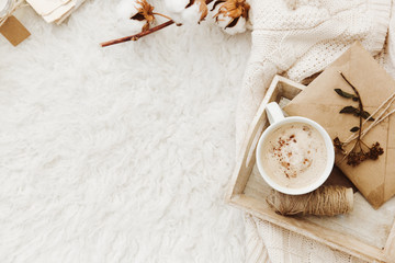 Winter cozy background with cup of coffee, warm sweater and old letters. Flat lay for bloggers