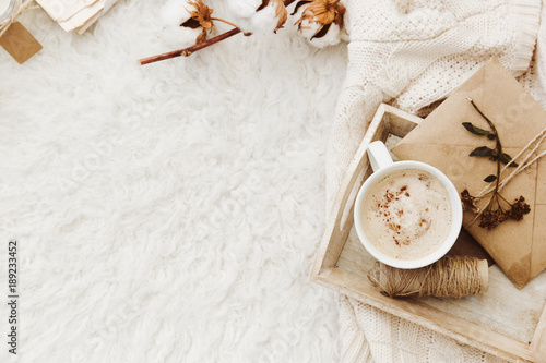 Winter cozy background with cup of coffee, warm sweater and old letters. Flat lay for bloggers photo