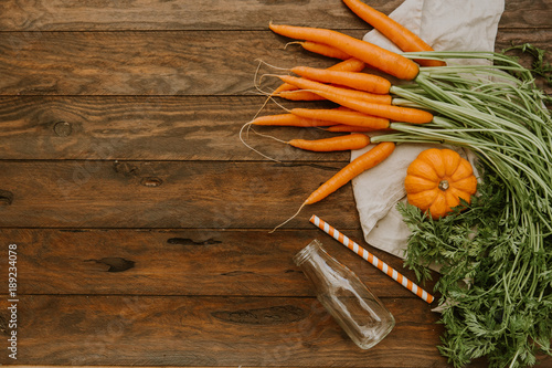 Fresh carrots on wooden background photo