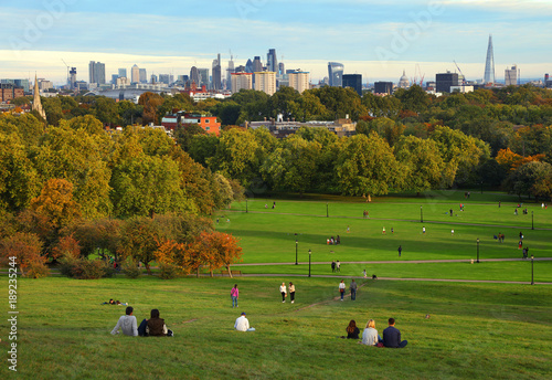 Photography People resting on Primrose Hill at sunset, London, UK