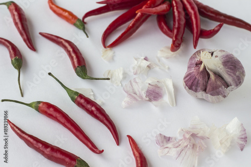 Red chili peppers and garlic cloves on a white background diagonally. Top view. Horizontally.