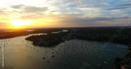 Aerial orange sunset over water and city landscape