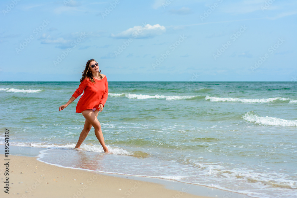A charming woman walks on the Black Sea coast A charming woman walks on the Black Sea coast