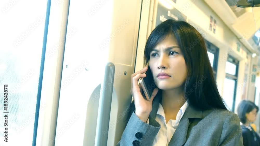 Asian woman using smartphone at city. Woman using smartphone for talking to customer. People working concept. Asian woman using smartphone at city. Woman using smartphone for talking to customer. People working concept.