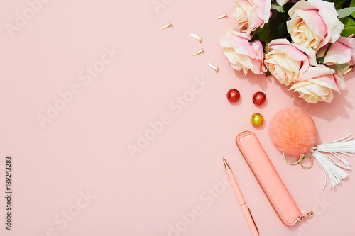 Female fashion accessories, pen, key ring on pink background, spring and summer table top flat lay