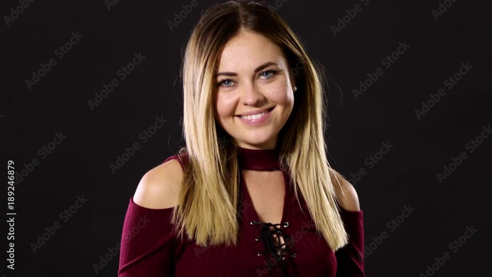 Pretty blond woman smiling and acting playful. Pretty blond woman smiling and acting playful.