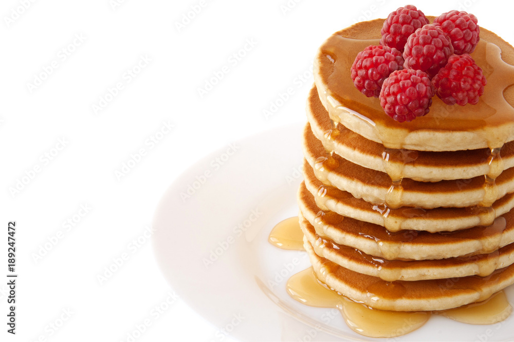 Pancakes Stack with maple syrup and raspberries isolated on a white background. Family Breakfast. Brunch. Shrove Tuesday. Mardi Gras. Snacks. Sweets. Food.