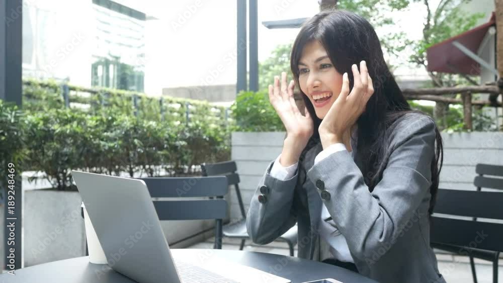 Asian business woman using laptop for live chat at restaurant. Woman working concept. Asian business woman using laptop for live chat at restaurant. Woman working concept.