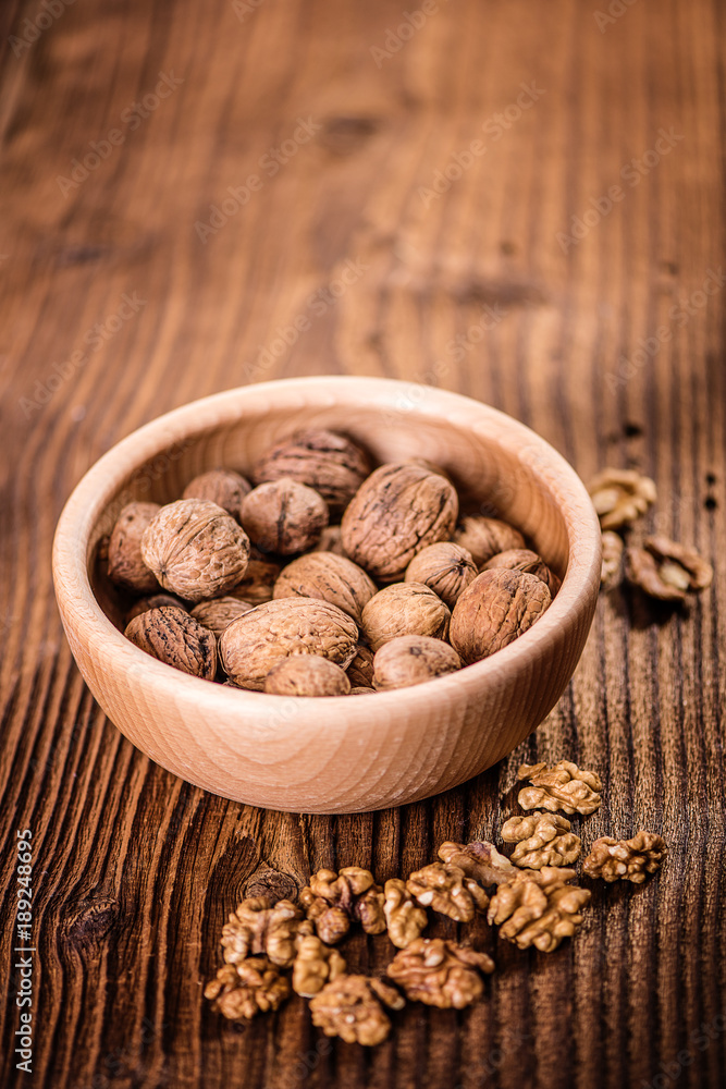 walnuts shells and kernels on old rustic wood background walnuts shells and kernels on old rustic wood background