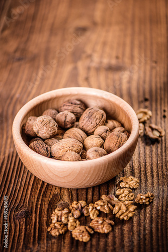 walnuts shells and kernels on old rustic wood background 