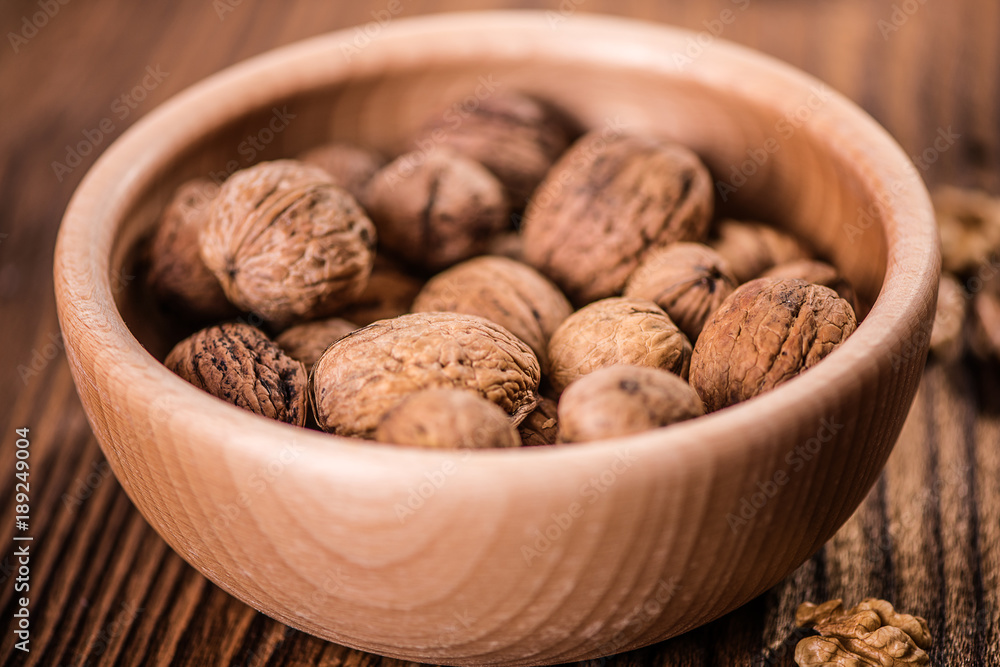 walnuts shells and kernels on old rustic wood background walnuts shells and kernels on old rustic wood background