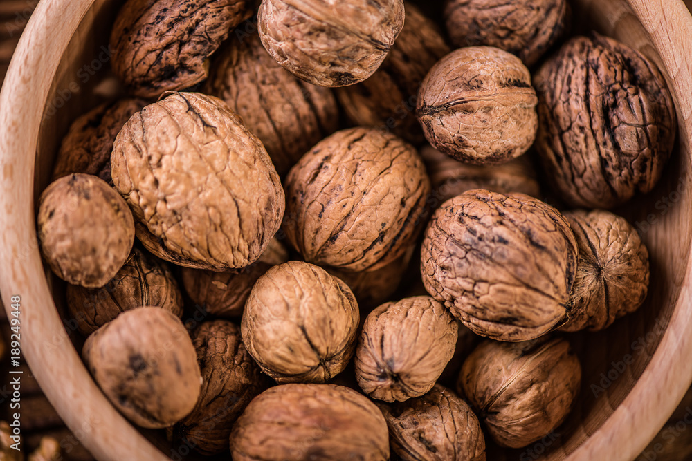 walnuts shells and kernels on old rustic wood background walnuts shells and kernels on old rustic wood background