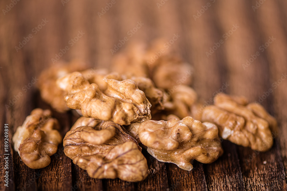 walnuts shells and kernels on old rustic wood background walnuts shells and kernels on old rustic wood background