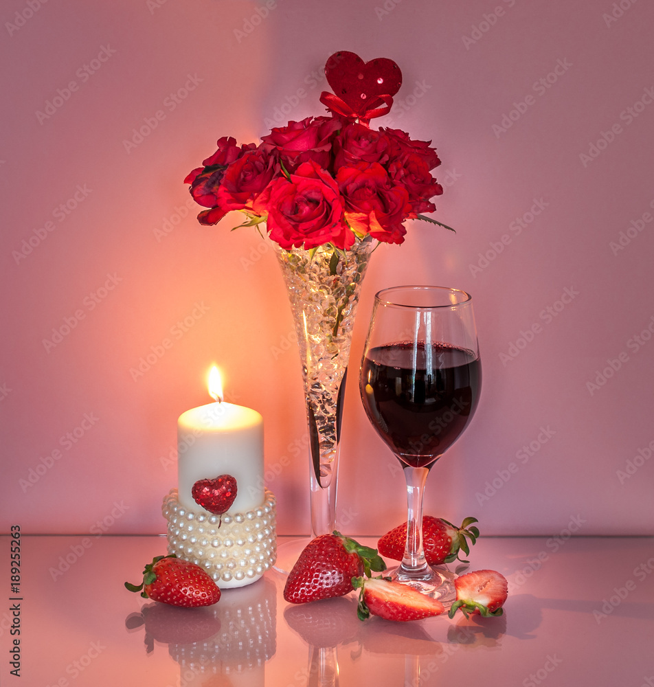 Romantic table decoration for Valentine's Day with wine, strawberries and candle