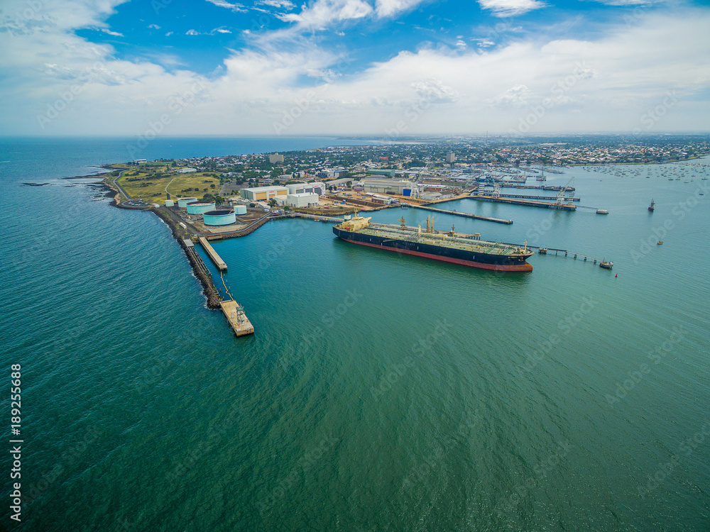Aerial view of industrial docks and nautical vessel at Yarra river mouth. Williamstown, Melbourne, Australia