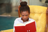 Scowling woman reading book
