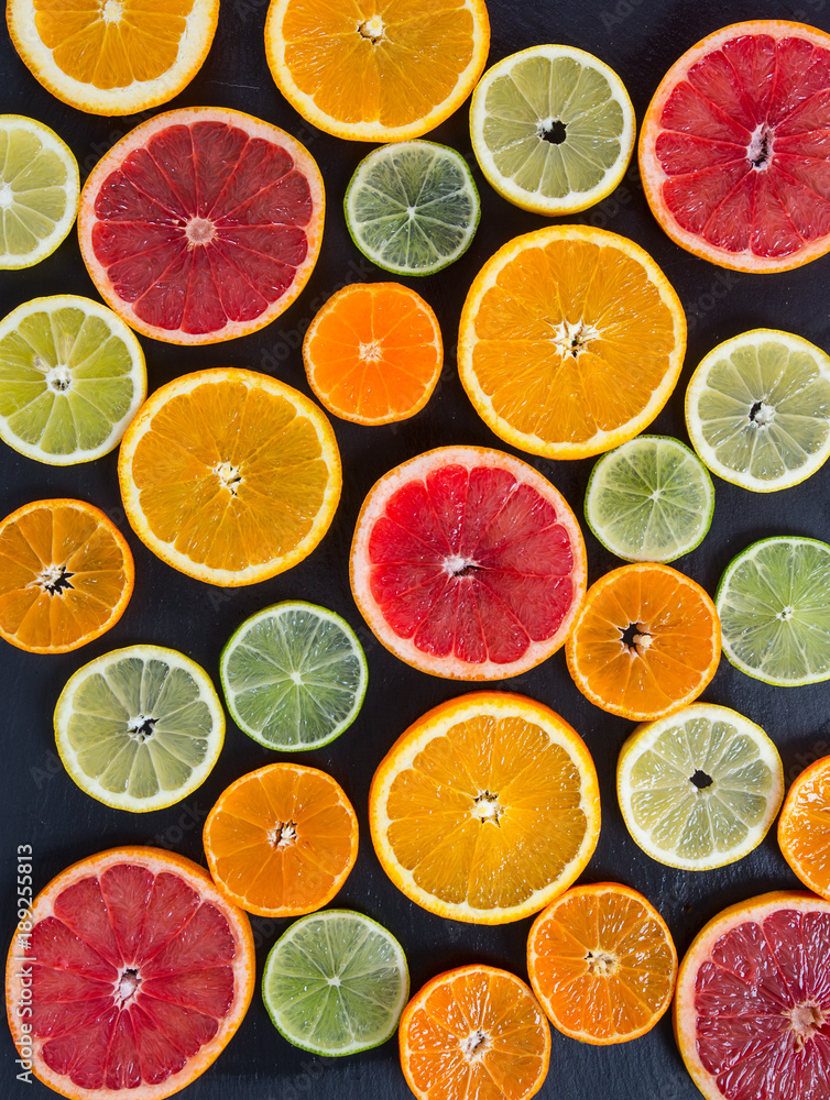 citrus fruit slices on dark surface citrus fruit slices on dark surface