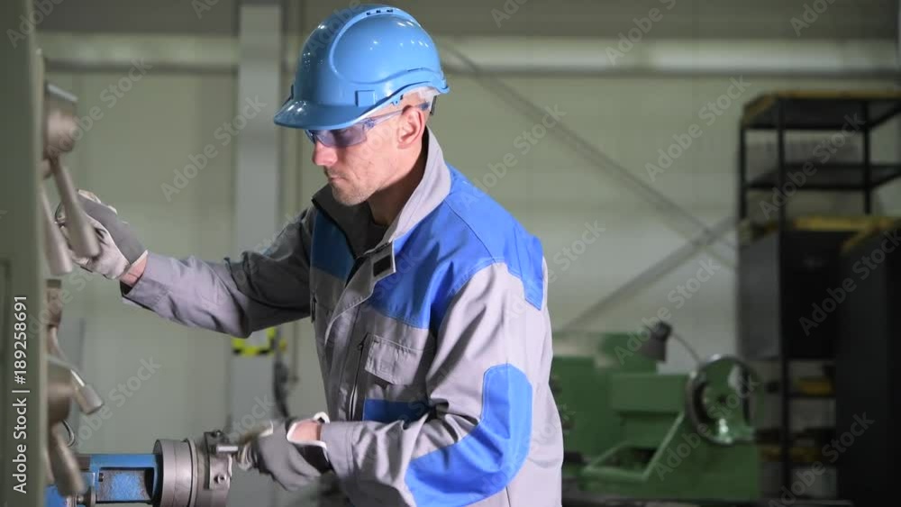 Caucasian Metal Processing Lathe Operator in His 30s During Machinery Material Processing. 4K Footage with Slight Motion Caucasian Metal Processing Lathe Operator in His 30s During Machinery Material Processing. 4K Footage with Slight Motion