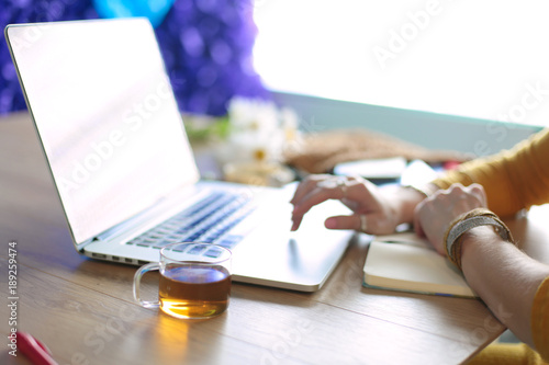 Young woman on a coffee break or enjoying the coffee-break, Using laptop computer © lenets_tan