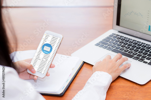 Asian woman sending email contact. gesture of finger pressing send on mobile smart phone and laptop computer, technology communication concept.