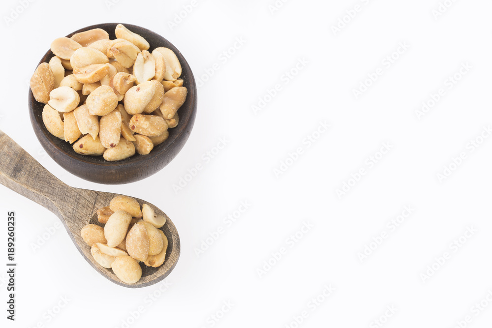 Toasted peanuts on wooden background - Arachis hypogaea Toasted peanuts on wooden background - Arachis hypogaea