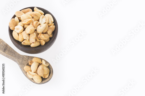 Toasted peanuts on wooden background - Arachis hypogaea