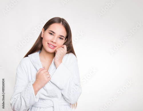 beautiful young woman with long hair wearing bath robe © Anetta