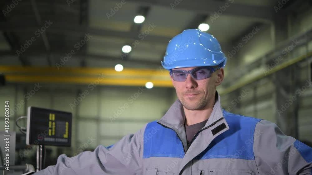 Caucasian Worker Wearing Safety Glasses and Blue Hard Hat. Caucasian Engineer Portrait. Caucasian Worker Wearing Safety Glasses and Blue Hard Hat. Caucasian Engineer Portrait.