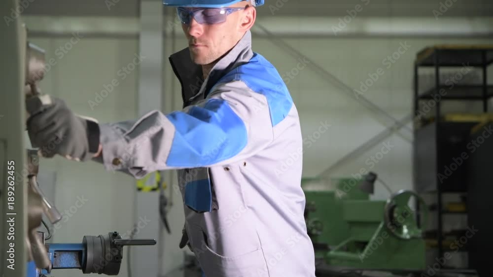 Caucasian Metal Lathe Operator in His 30s During Metal Processing Work ...