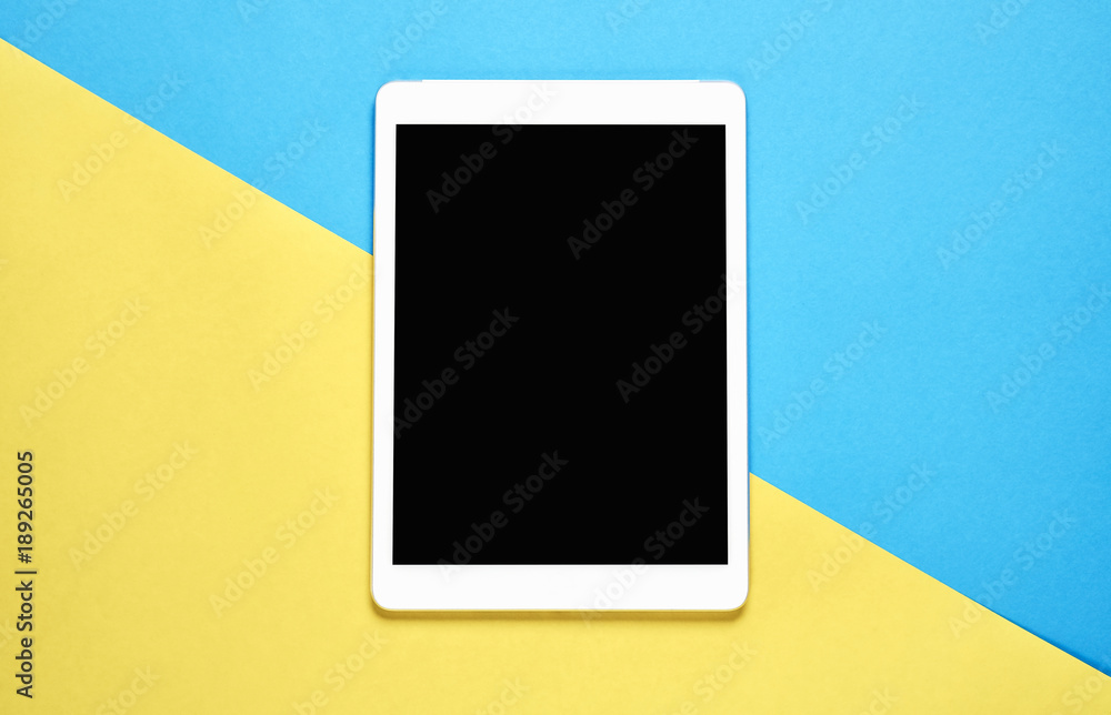 Top view, Modern workplace with tablet placed on a pastel yellow background. Copy space suitable for use in graphics. Top view, Modern workplace with tablet placed on a pastel yellow background. Copy space suitable for use in graphics.